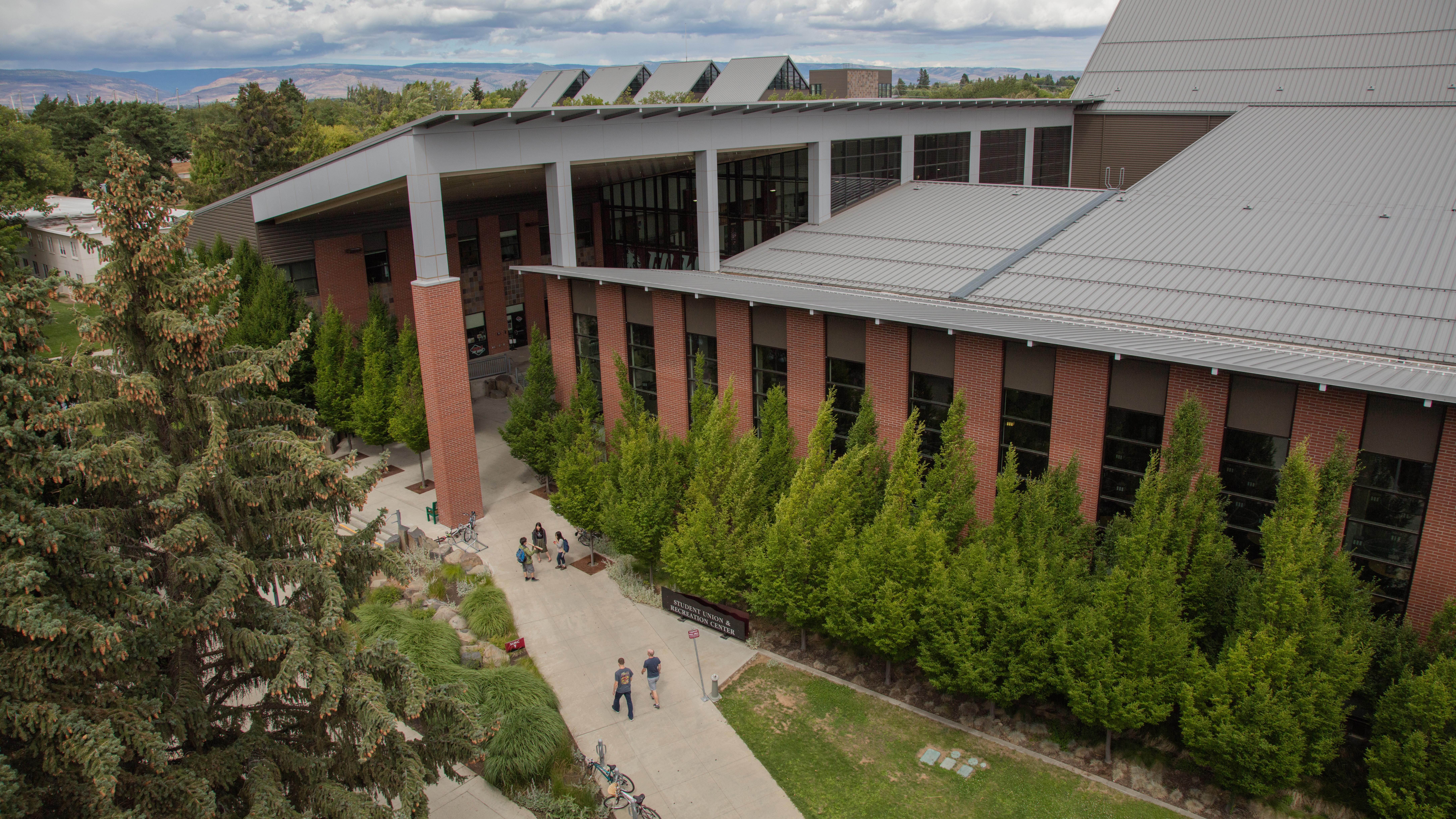 An image of the outside of the SURC taken from the sky. There are a lot of windows and there's trees around the building. It is the west side of the building.