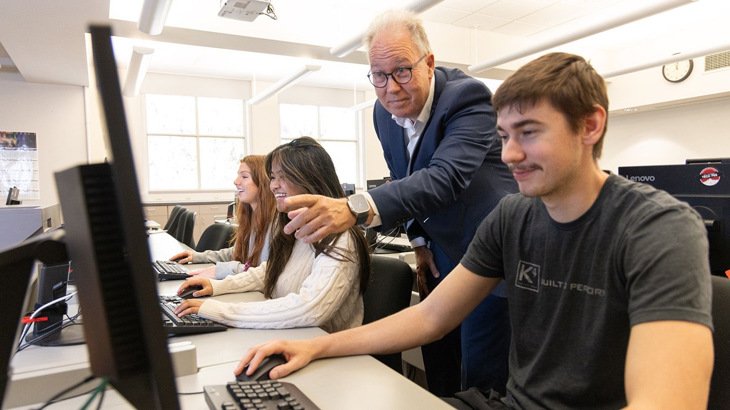 A professor at Central Washington University works with an accounting student in the computer lab
