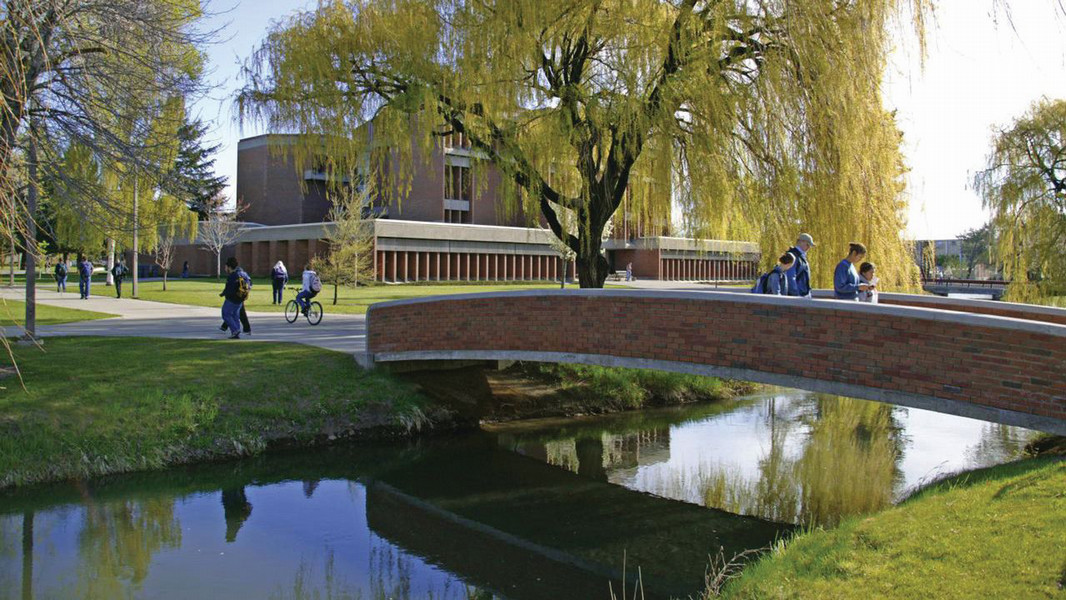 Students at Central Washington University take a walk across the bridge.
