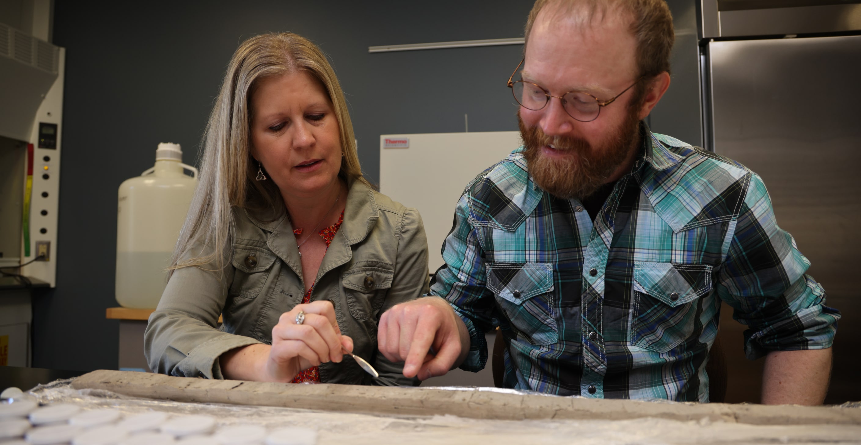Student and professor working on sampling ash