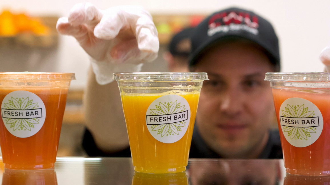 A man who works within the dining facility at Central Washington University ensuring that the Fresh Bar smoothies are ready to be purchased and enjoyed.