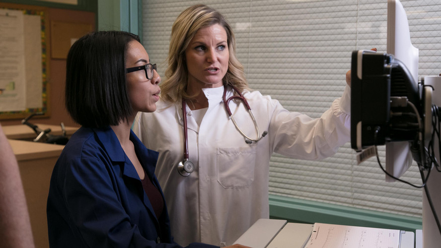 A doctor shows a student how to use the computer with the heath careers program at Central Washington University.