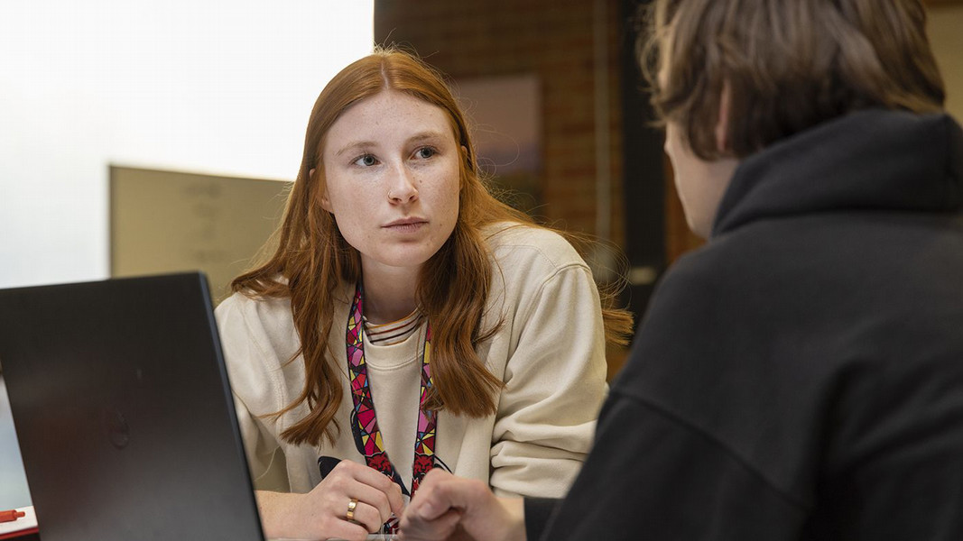Two students at Central Washington University engage in conversation within the Learning Commons.