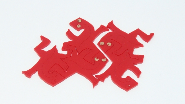 cut red acrylic Eischer puzzle of lizards that interlock with each other