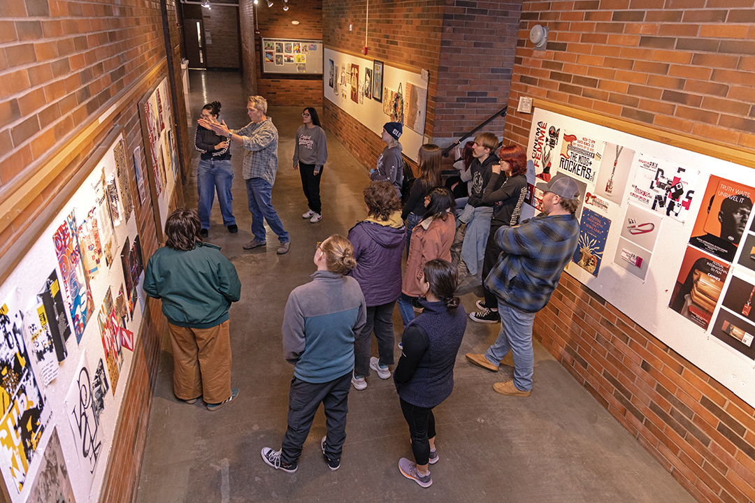 Graphic Design Professor David Bieloh, center, aims to help his students enter their professional careers as “better citizens, thinkers, and problem-solvers.”