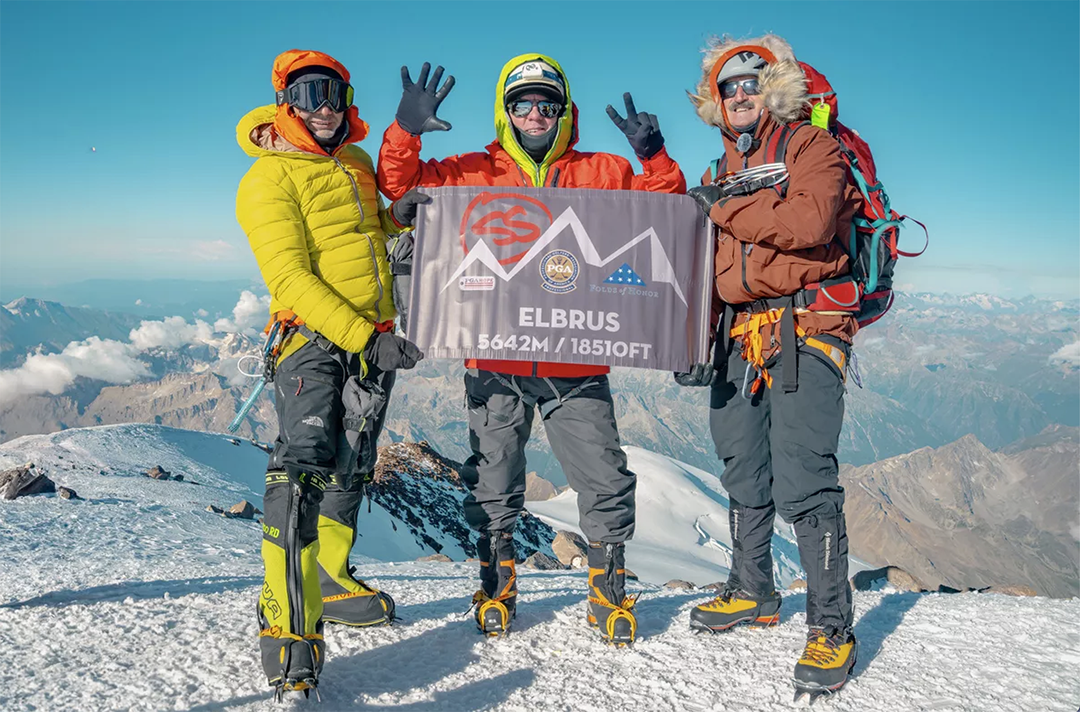Climber Steve Stevens holds up seven fingers at the top of Mt. Elbrus last summer.