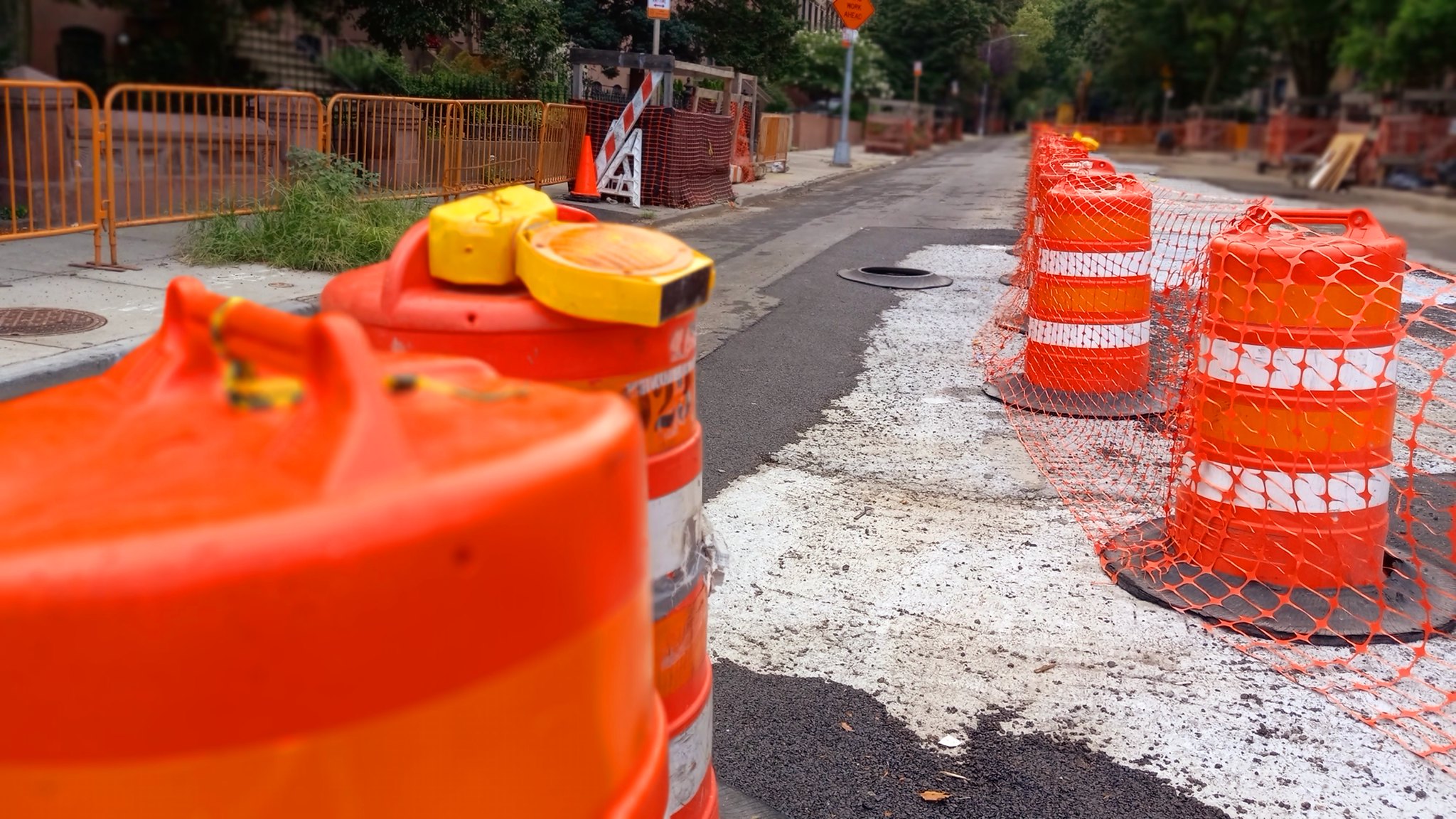 orange hazard bollards placed on street indicating caution