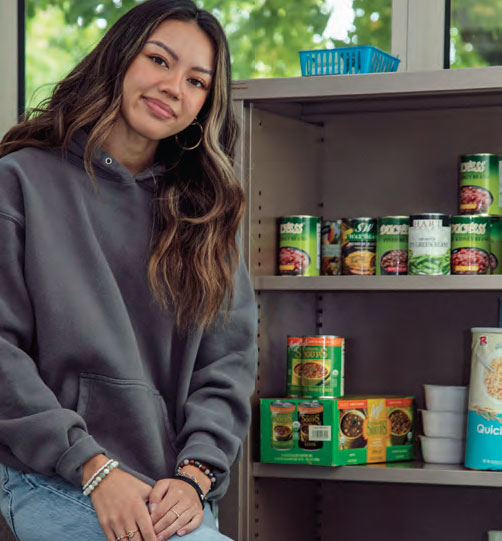 PUSH Pantry coordinator standing next to food
