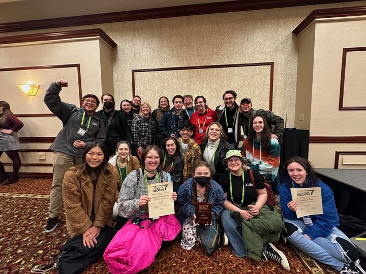 large group of people holding flyers
