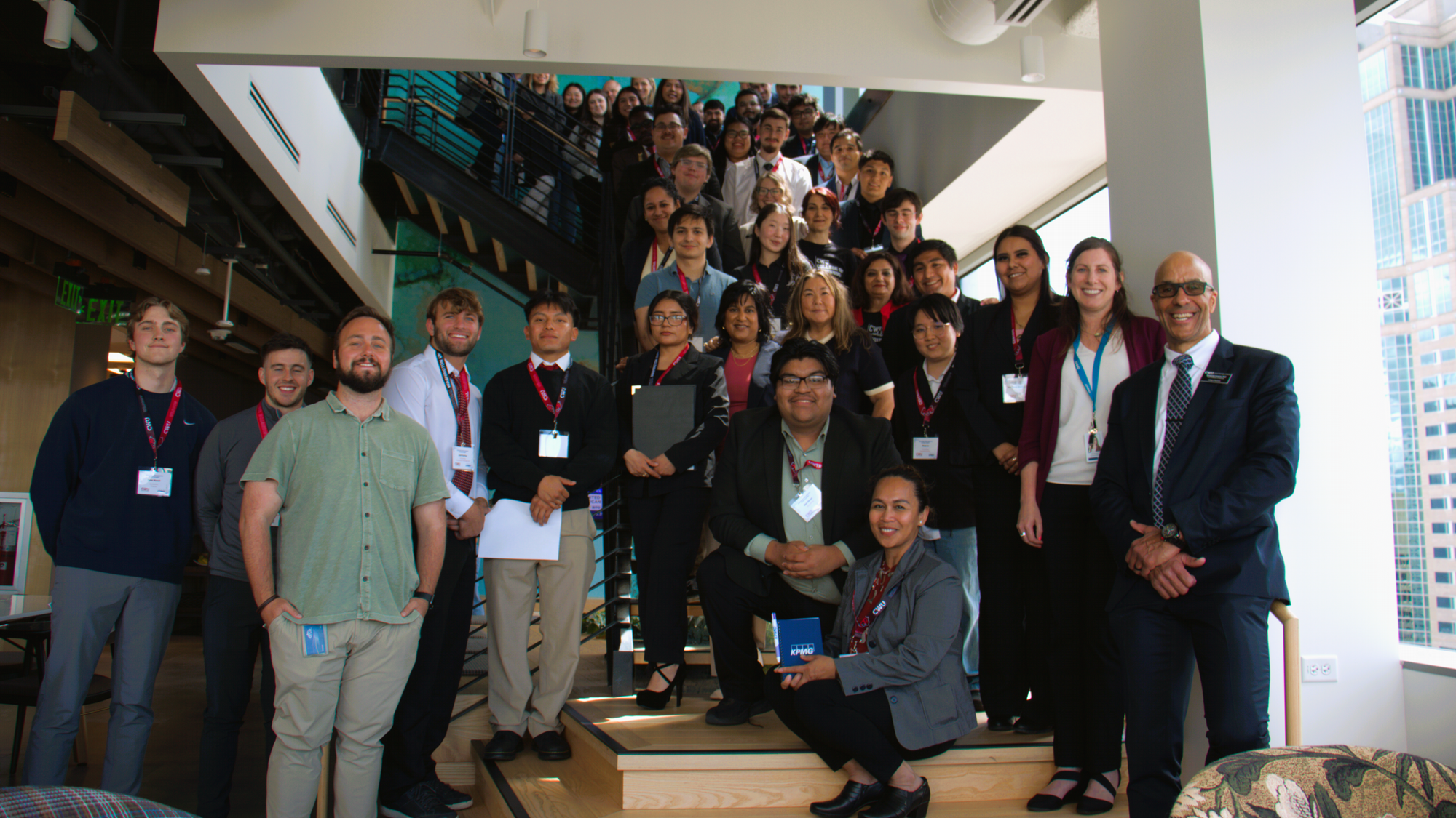 Students on stairs attending KPMG Reaching New Heights Intern Summit in May 2025