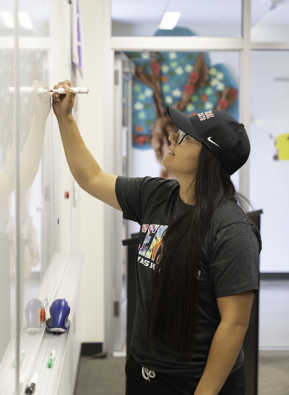 Student writing on a whiteboard