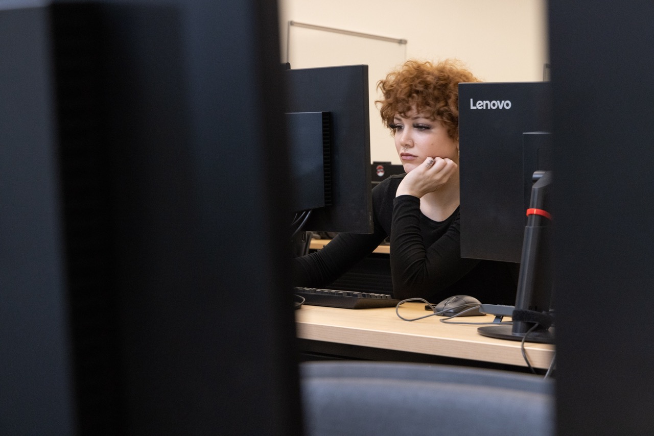 A CWU student working on a computer.