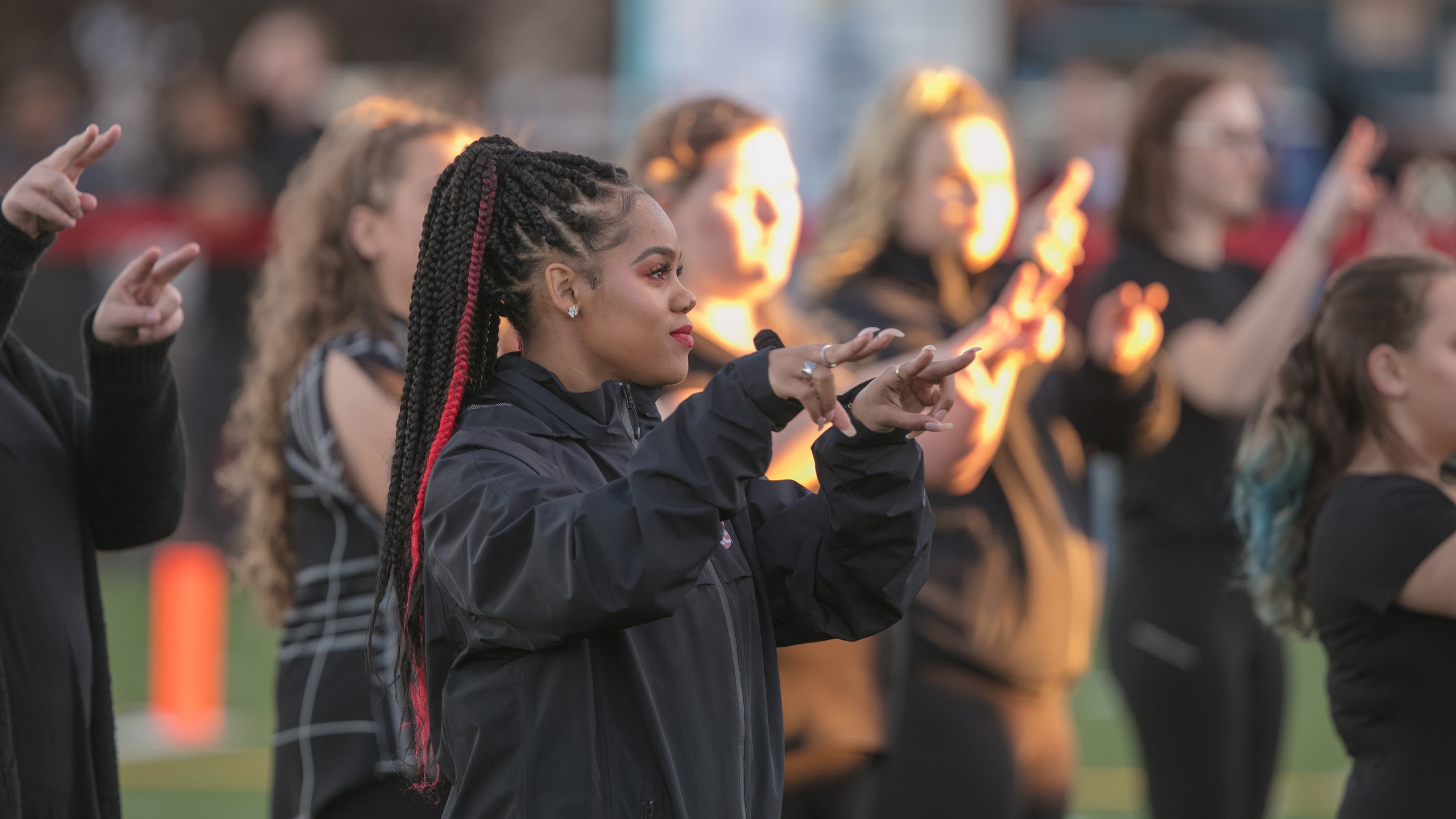 Students signing the national anthem during a sport event