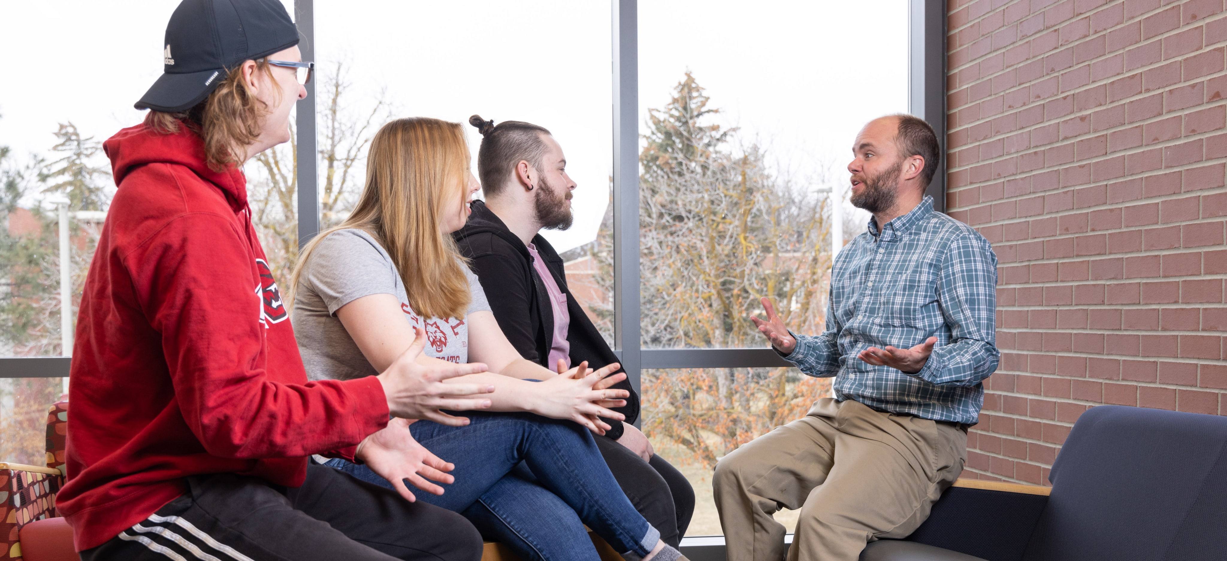 Students talking with a professor outside of the classroom