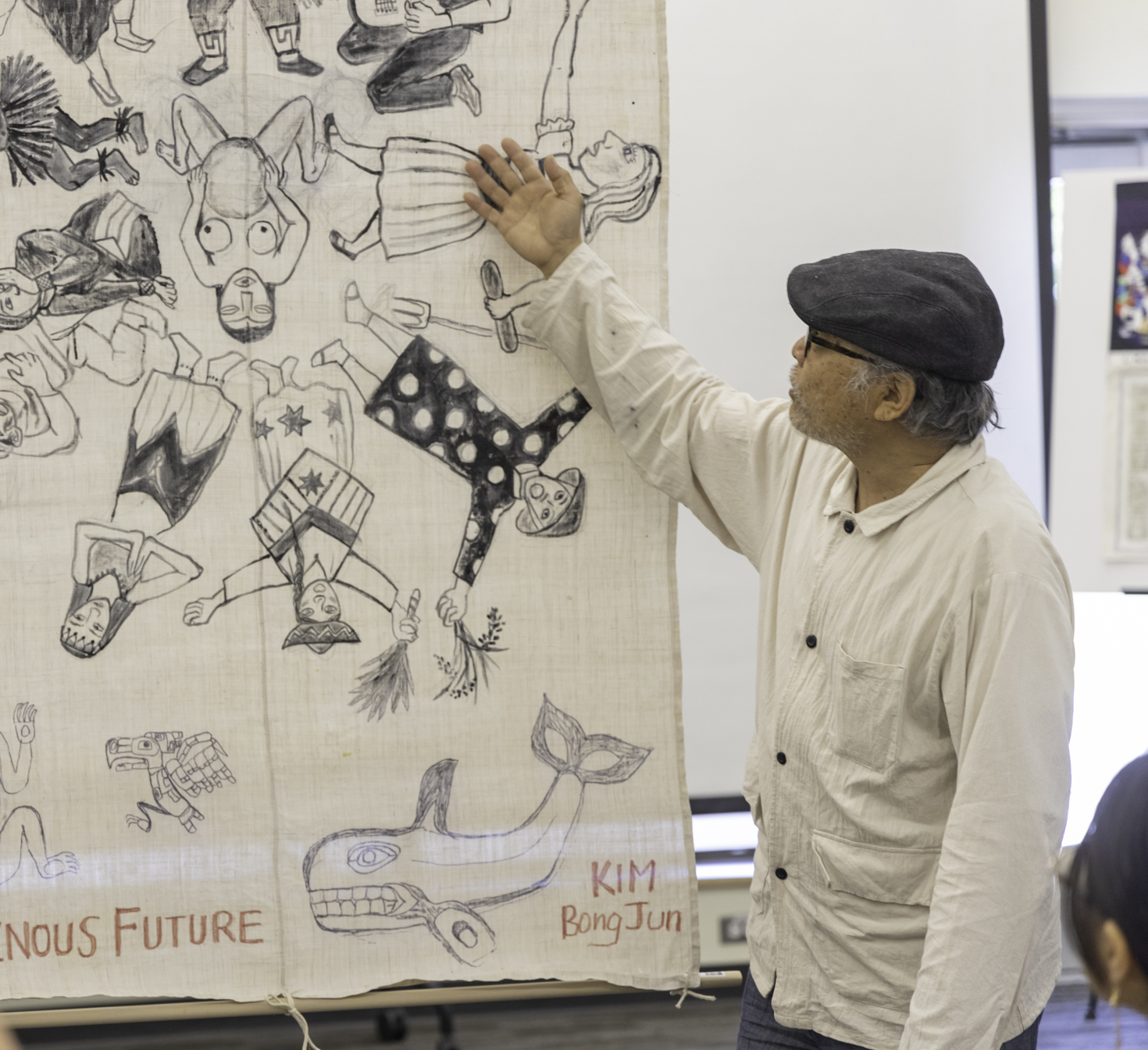 Asian artist discussing his art in a presentation