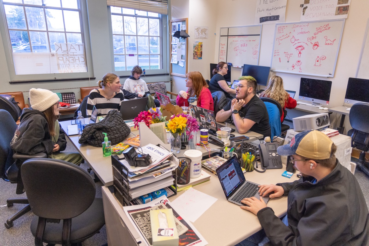 Classroom filled with students working together on class projects