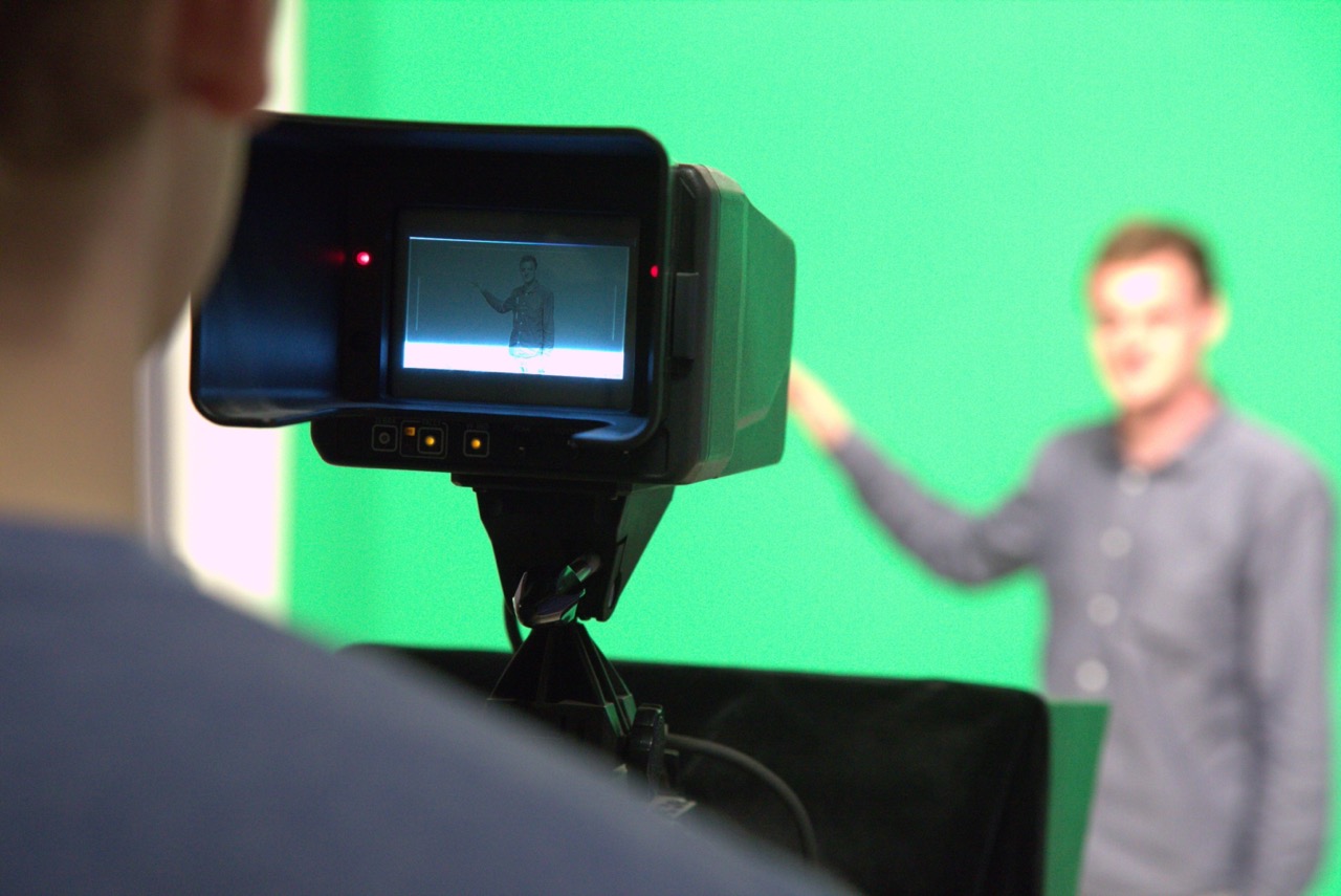 Student working at a greenscreen