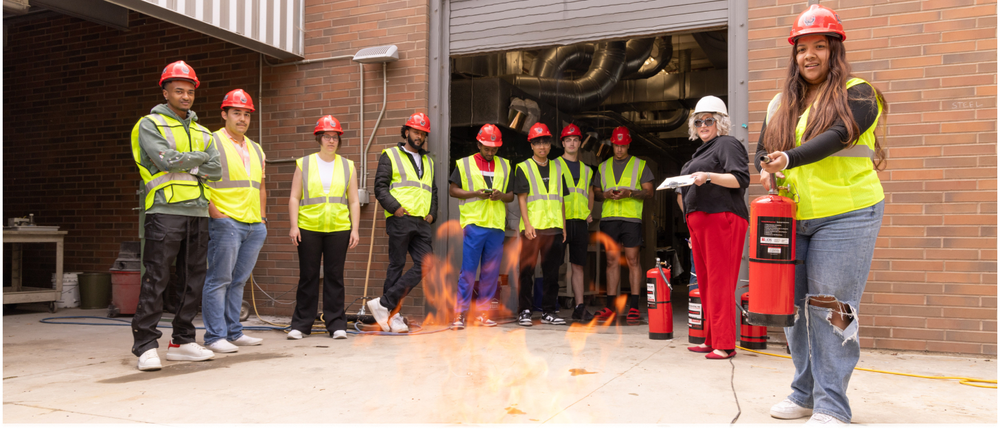 Students putting out a fire in a fire suppression drill