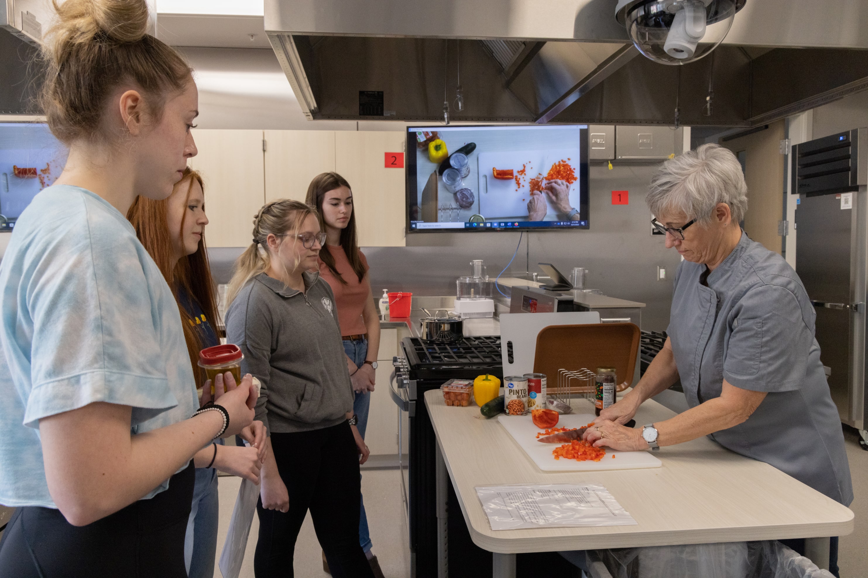 Students working in the Nutrition kitchen dicing vegetables