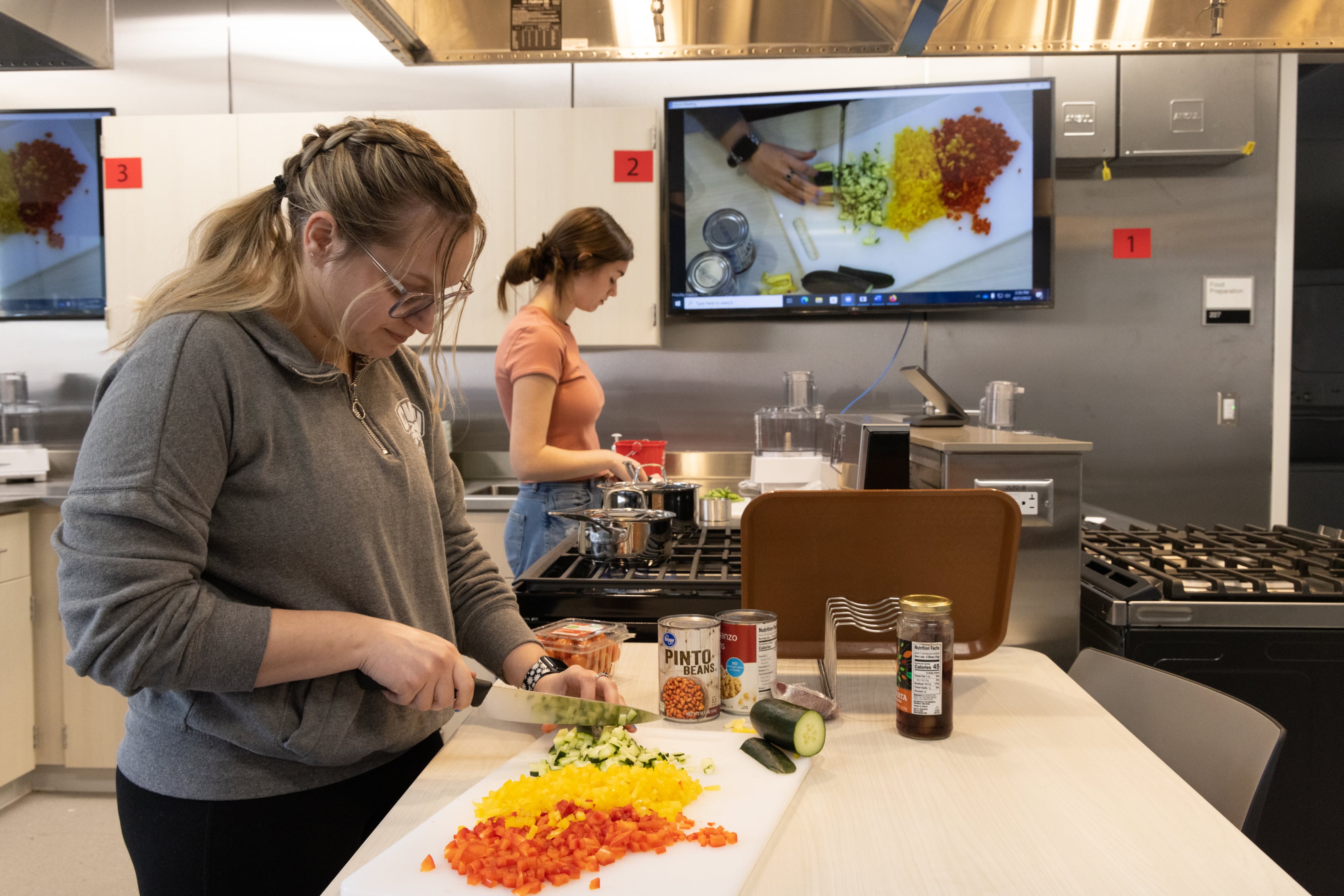 Students working in the Nutrition kitchen dicing vegetables