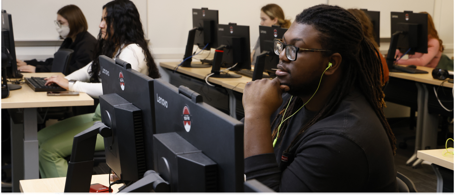 Student sitting in a computer lab.