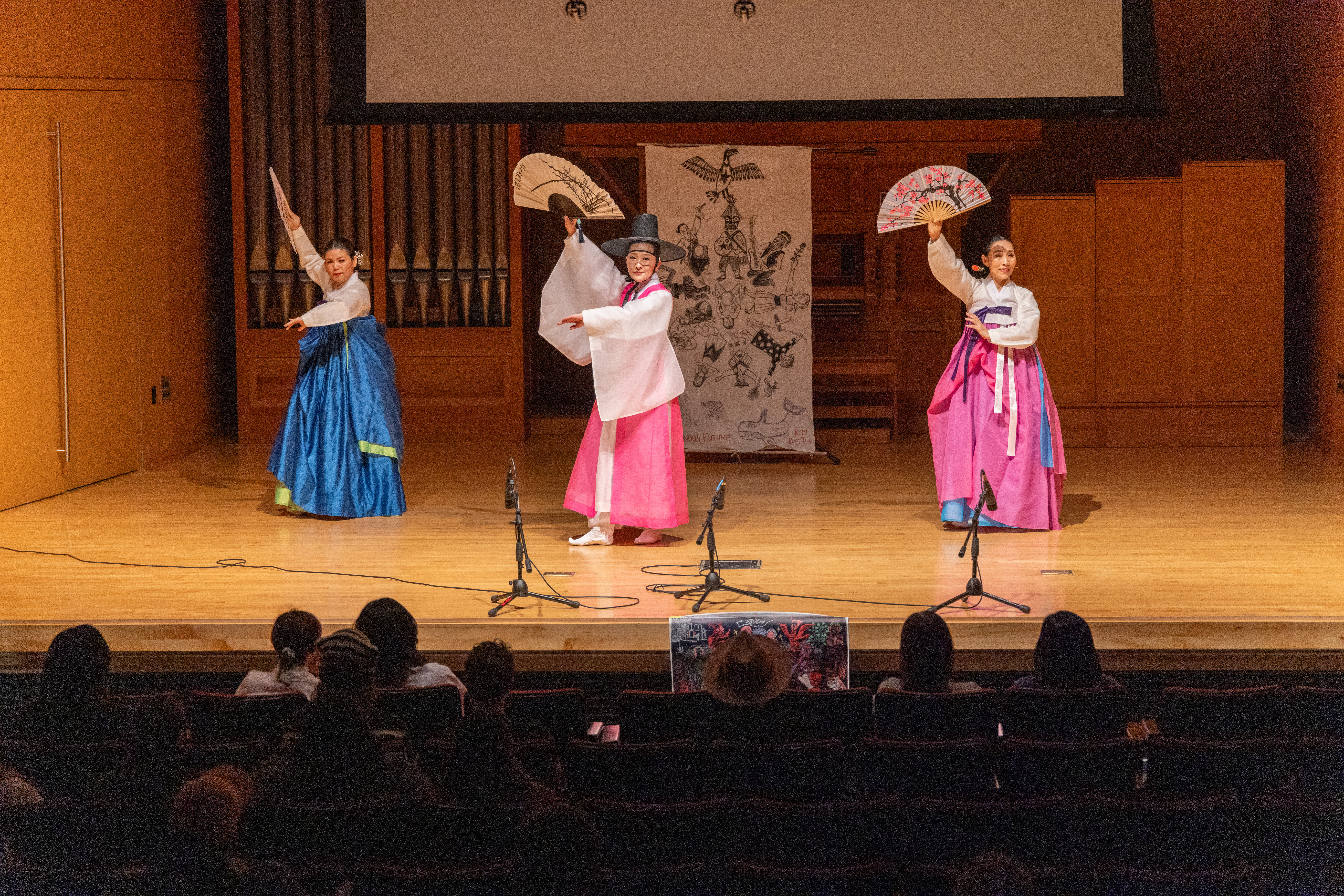 Traditional Korean dancers dancing on a stage
