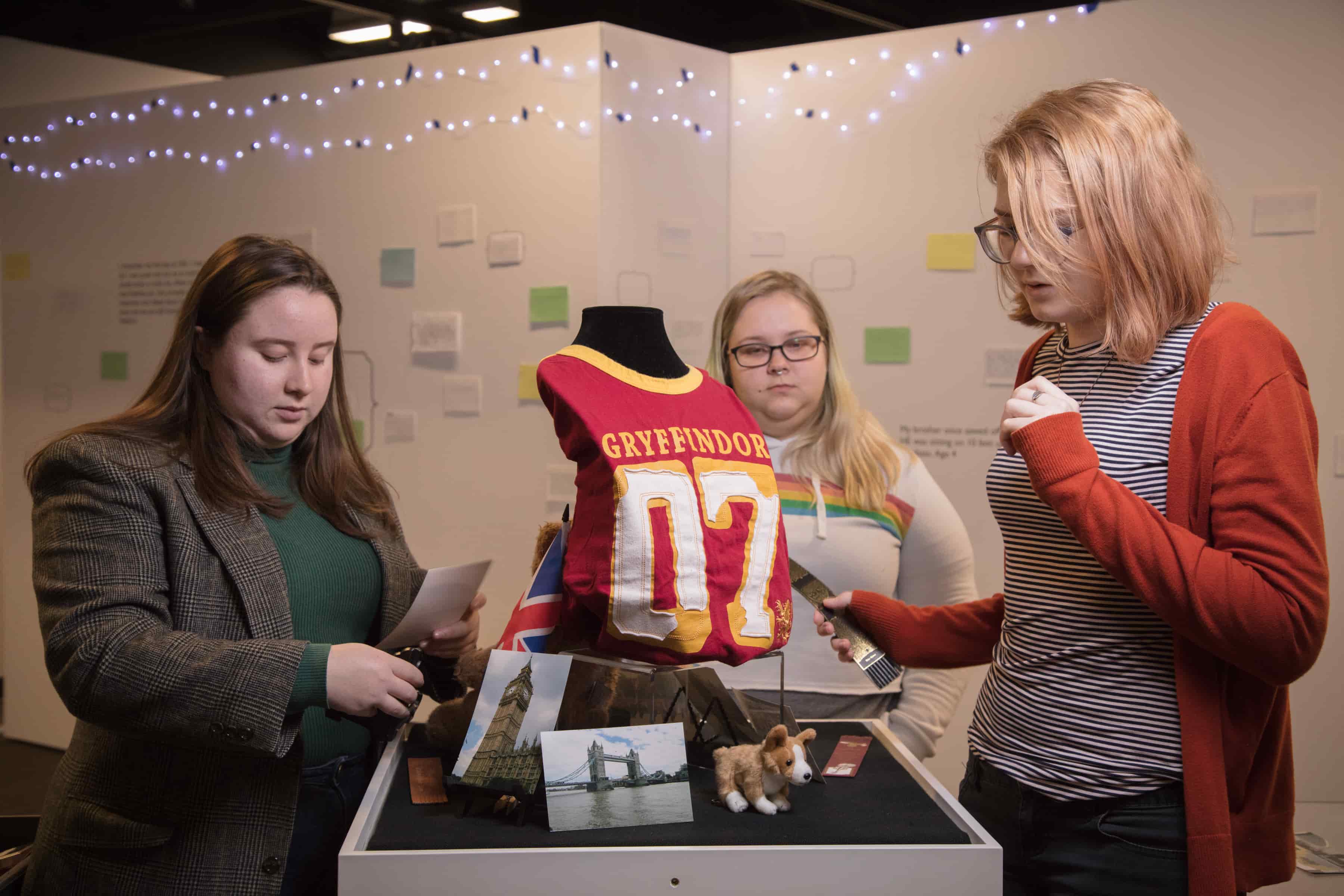 Three CWU students learning how to curate a museum exhibit.