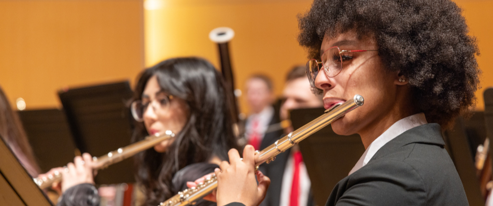 Two students playing the flute