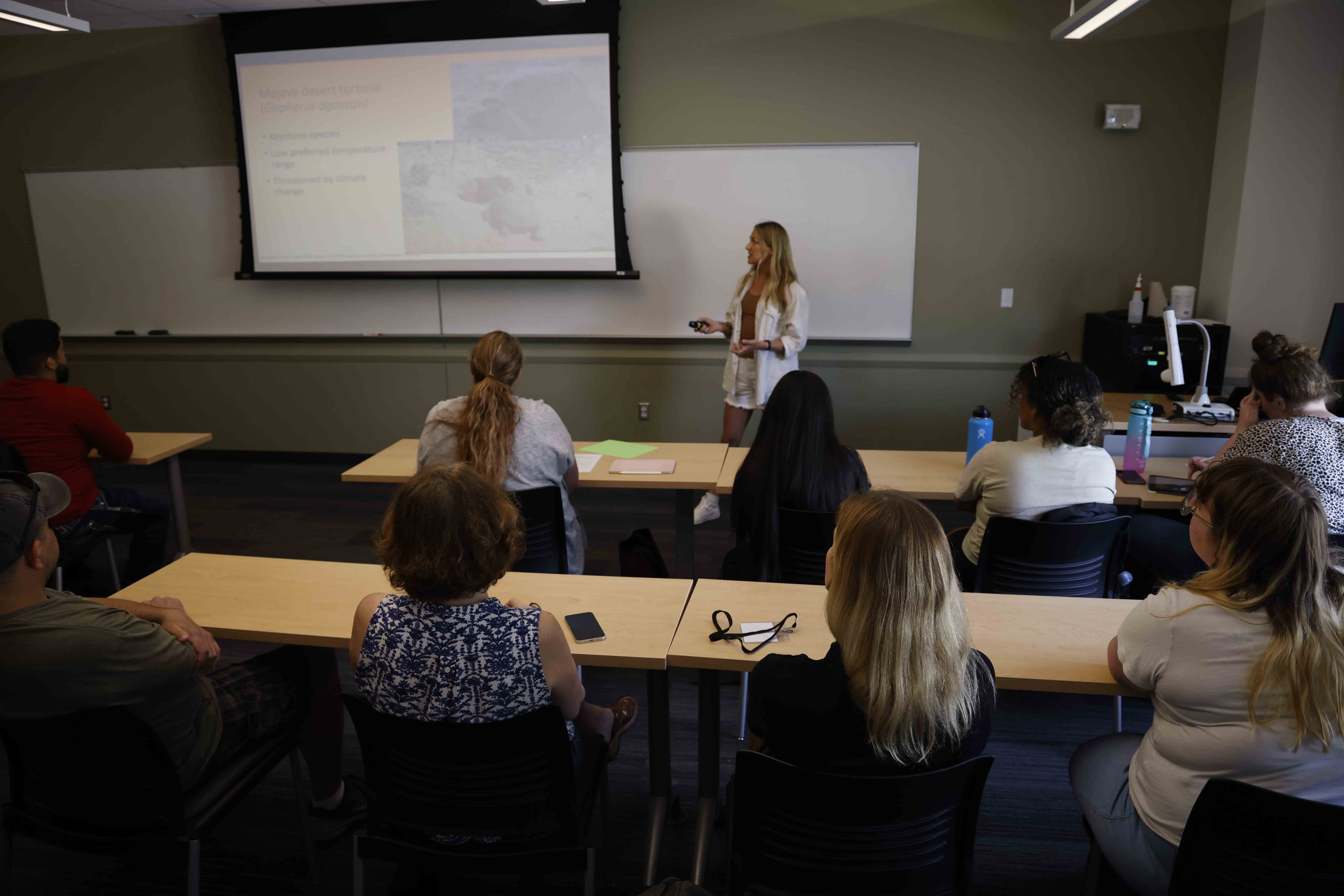 Student presenting to other students in the classroom.