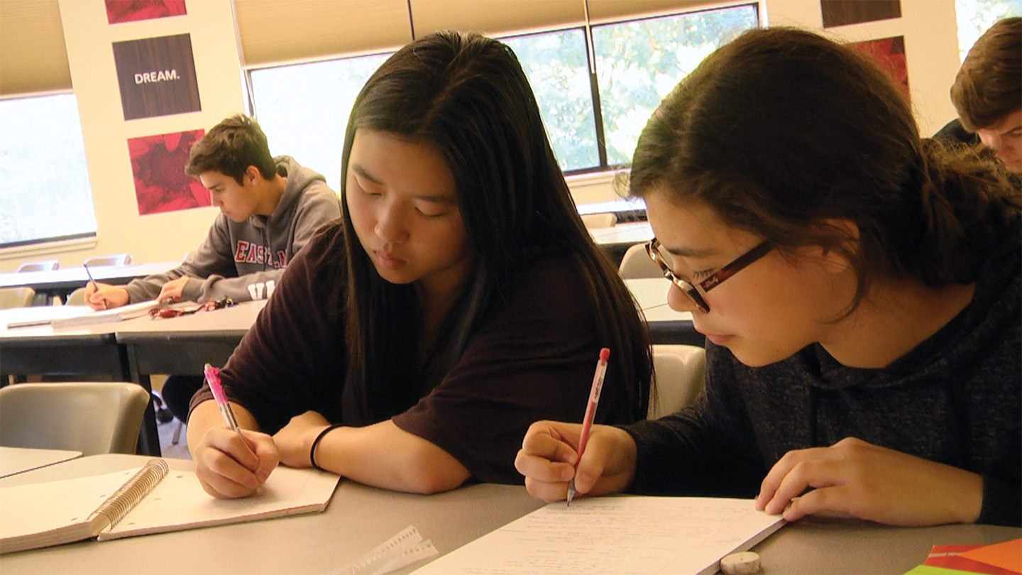Students sitting at a desk doing homework
