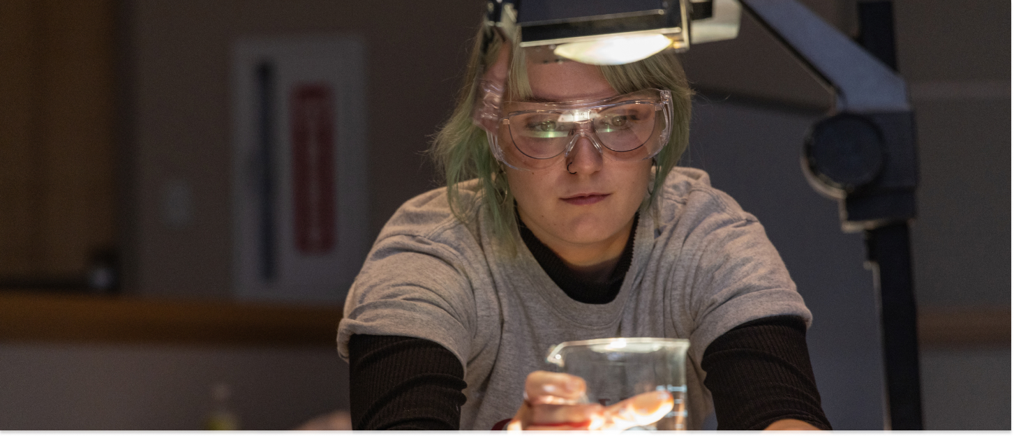 Student looking at a microscope