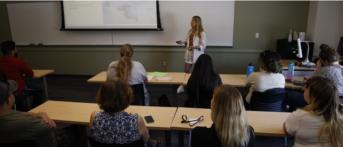 Student presenting in front of class. 