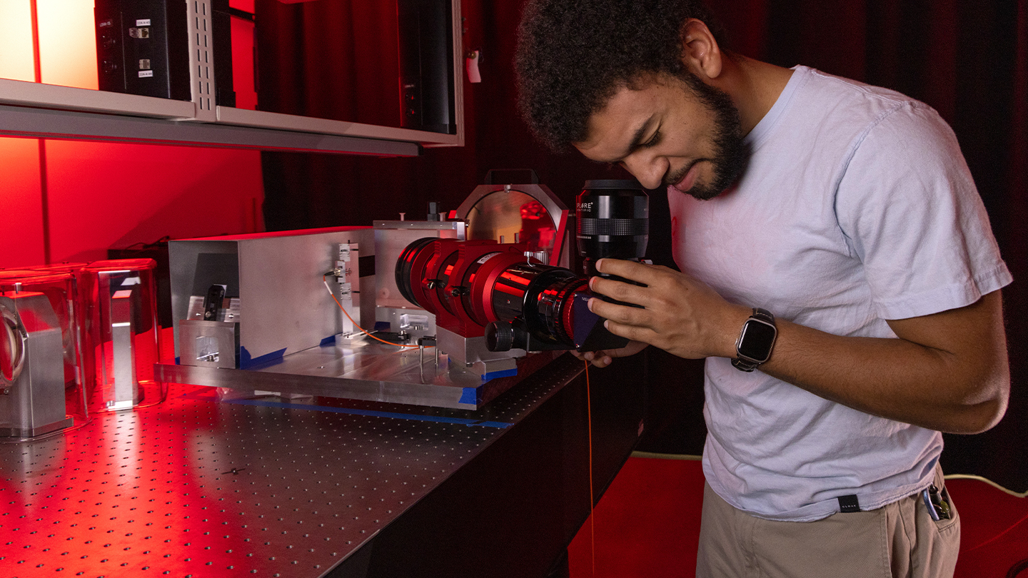 student looking through lens
