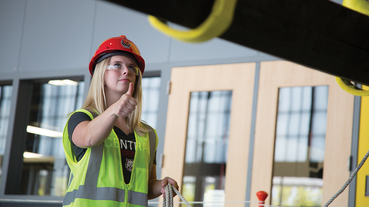 safety management student with a hard hat gives tumb up