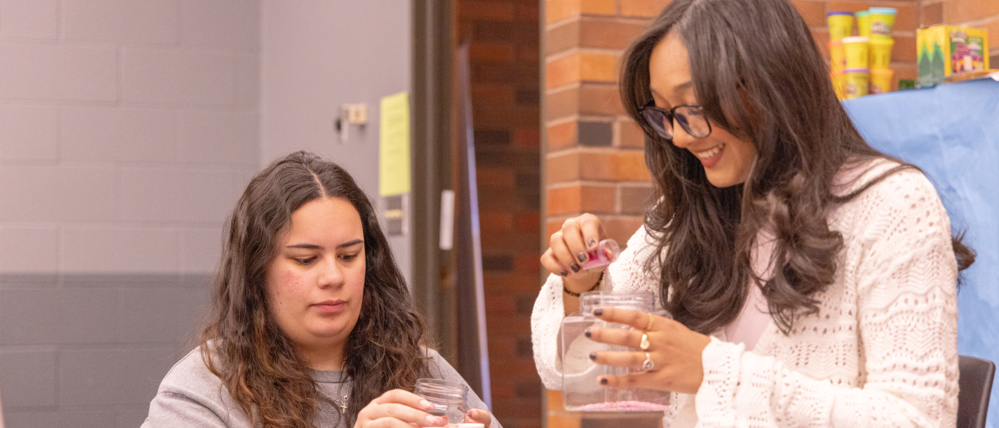 students holding jars