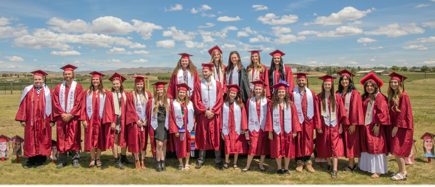 FCS students posing for a photo in cap and gowns