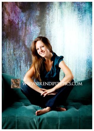 Allison Shin sitting on a green velour sofa