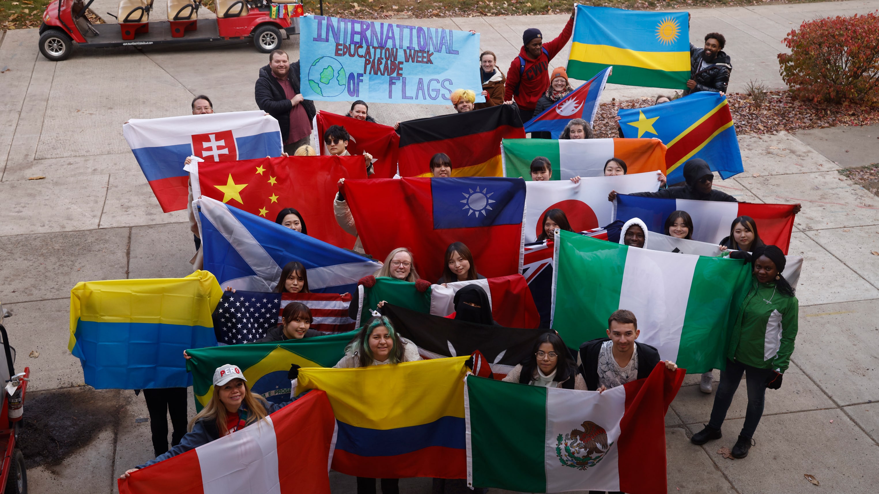 Students holding up flags for international student week.