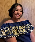 Eunice Magana smiling in a photo. Her hair is tied back