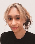 Karla Maravilla smiling in a selfie. Her hair is tied back.