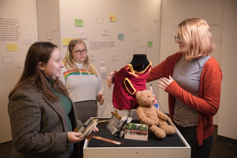 Three students from the CWU Museum Club install their 2019 exhibit Thanks for the Memories.