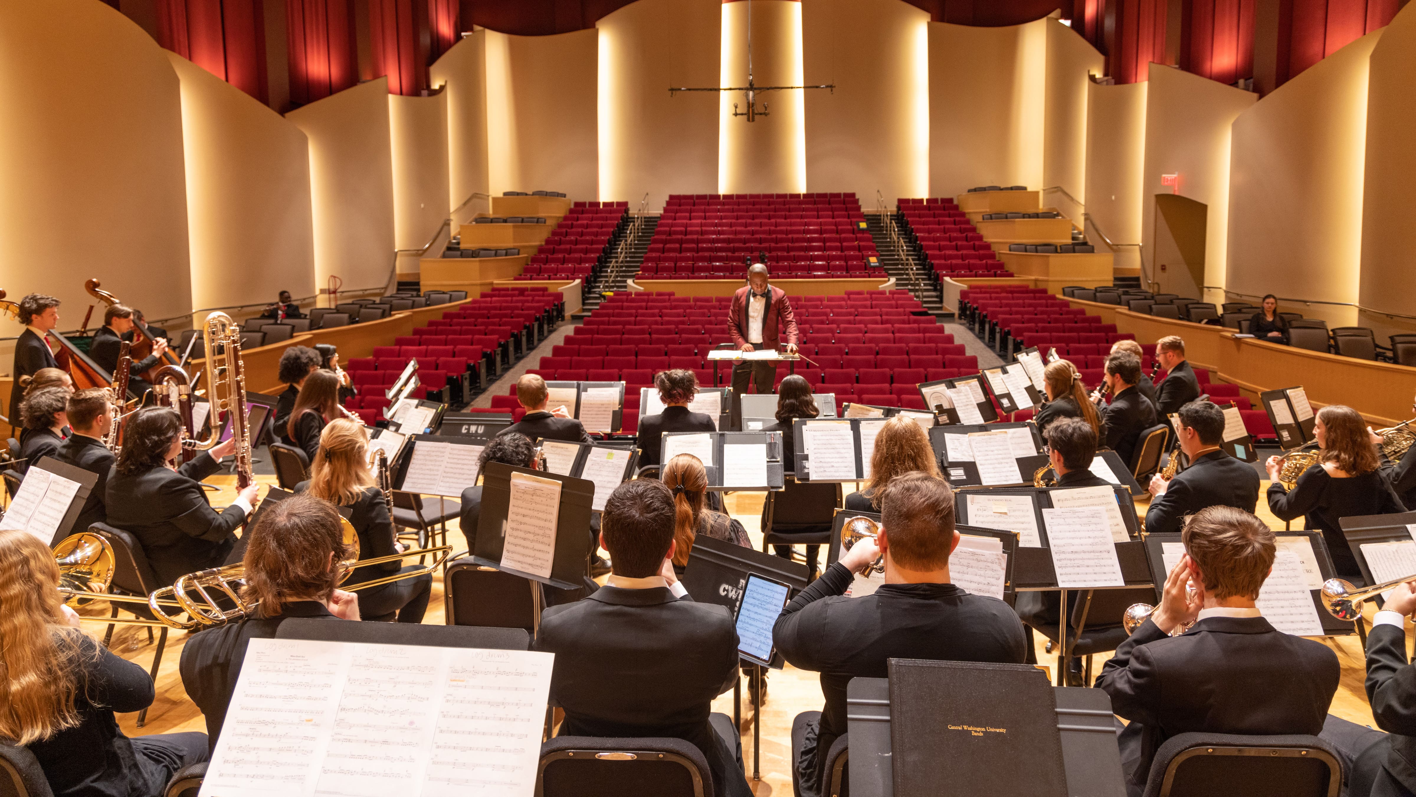 Wind Ensemble rehearsing on the concert hall stage.