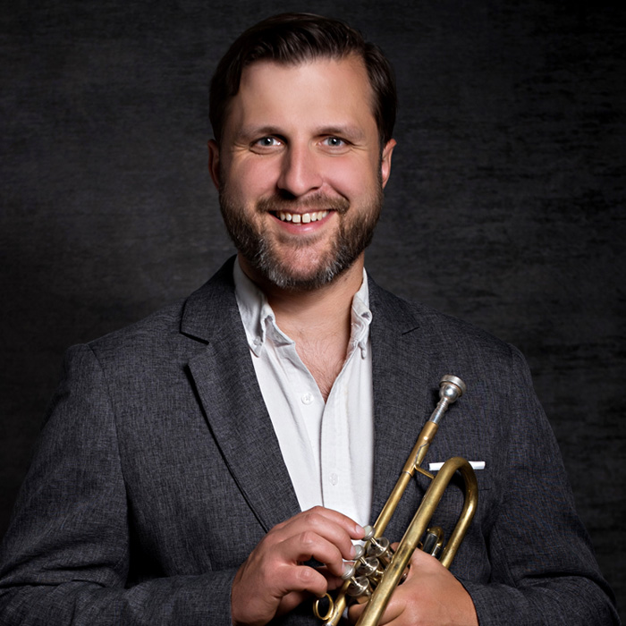 Image of Dr. Keith Karns holding trumpet.