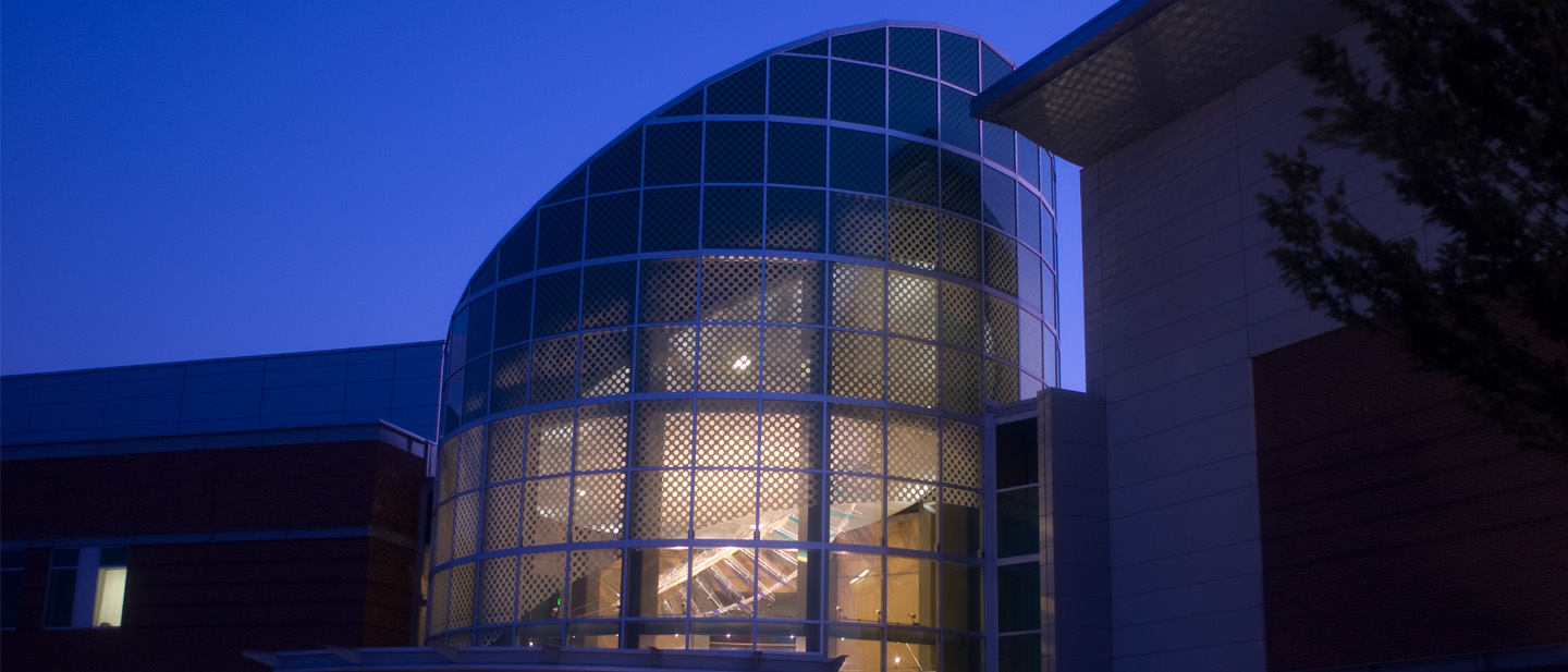 Beautiful cobalt blue sky behind the cylindrical glass tower of our rotunda. Taken at dusk the interior lighting shines through creating a beautiful image.