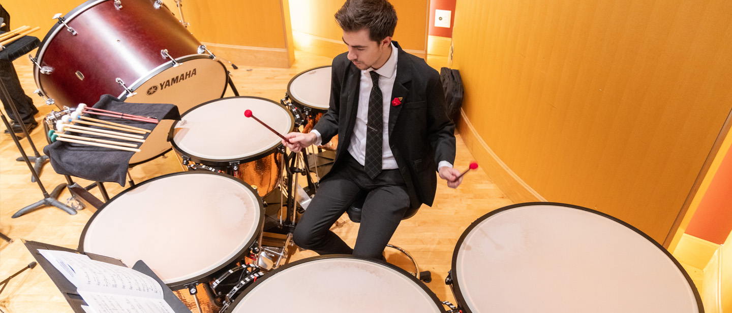 Student plating the timpani drums.