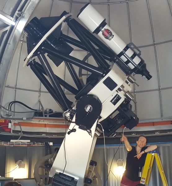 telescope, there is a woman using it