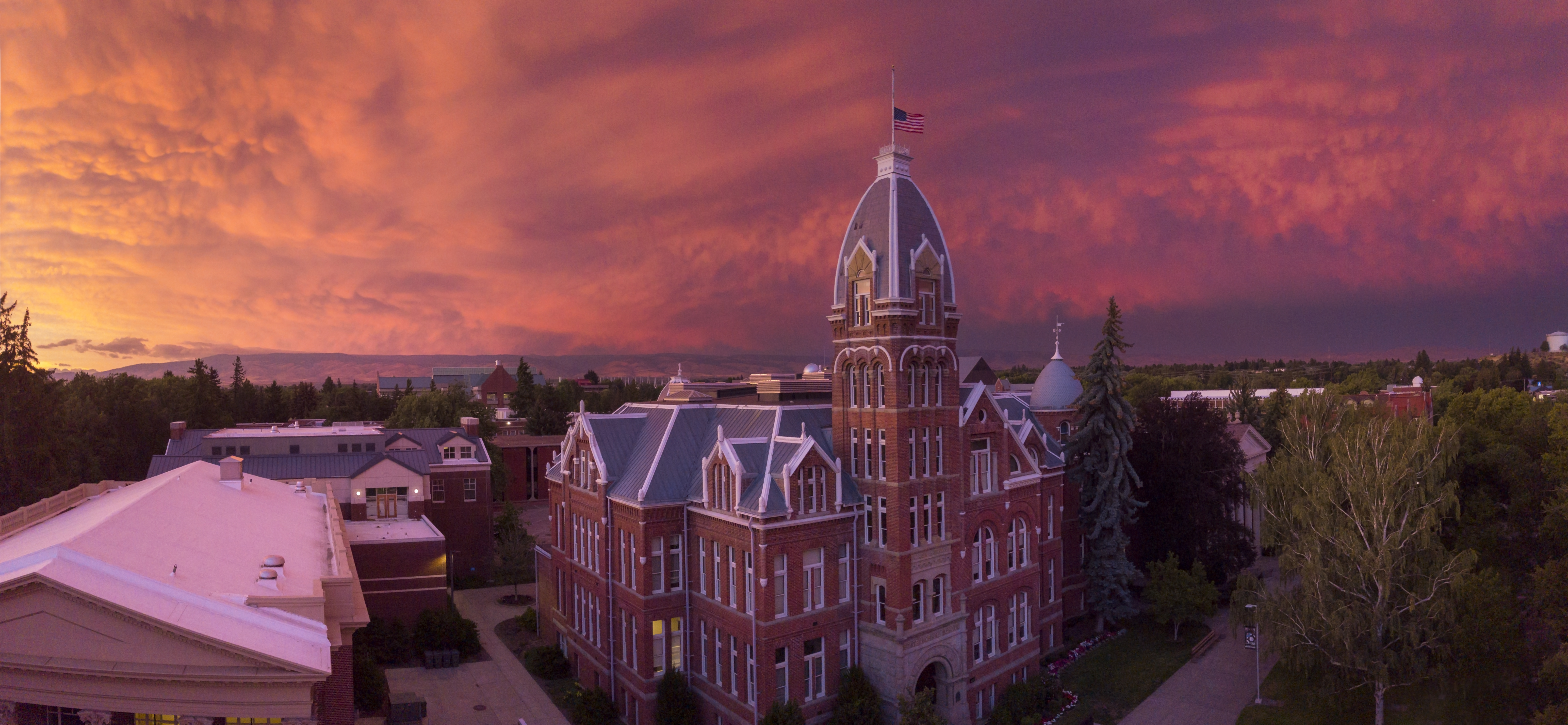 Aerial view of Barge hall with a pink and purple sunset.