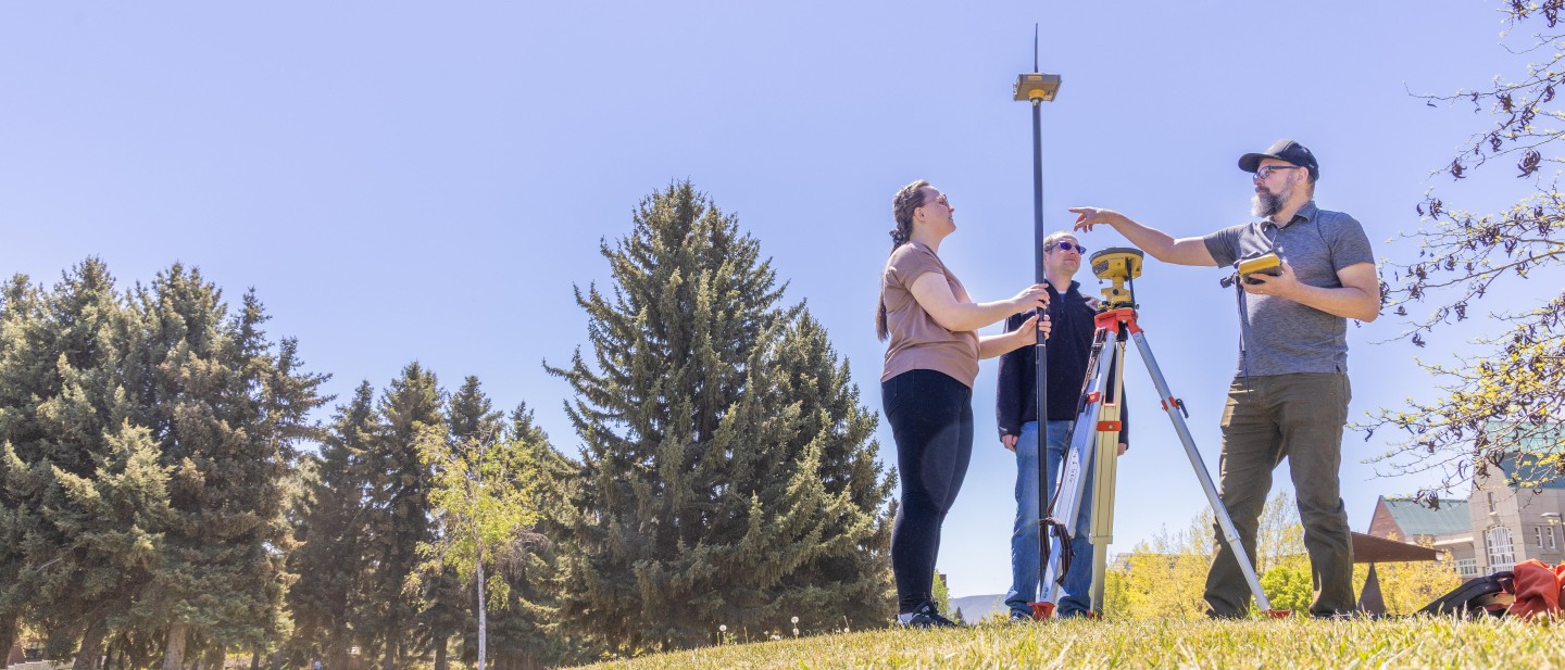students outside working with equipment
