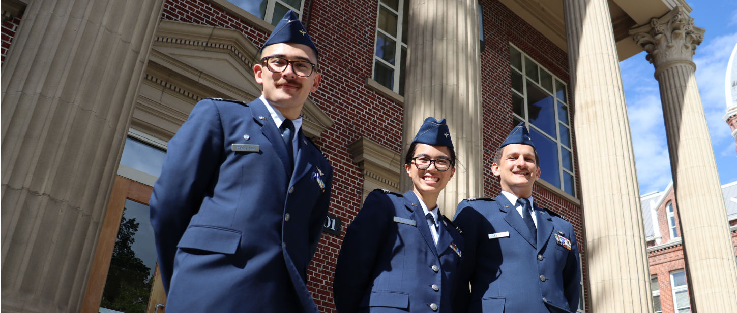 3 students in their formal uniforms posing for a photo