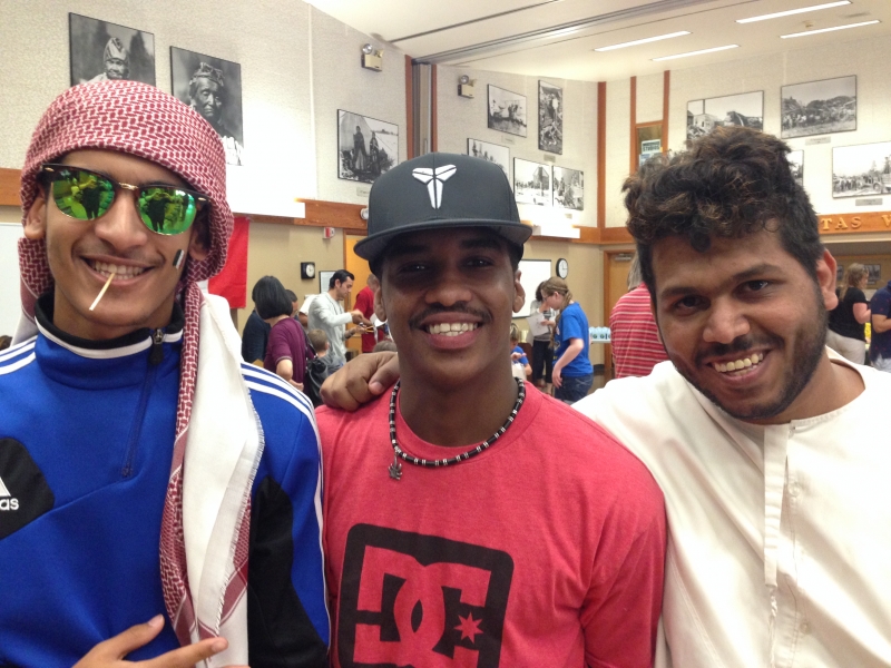 3 ESL students smiling at the camera.